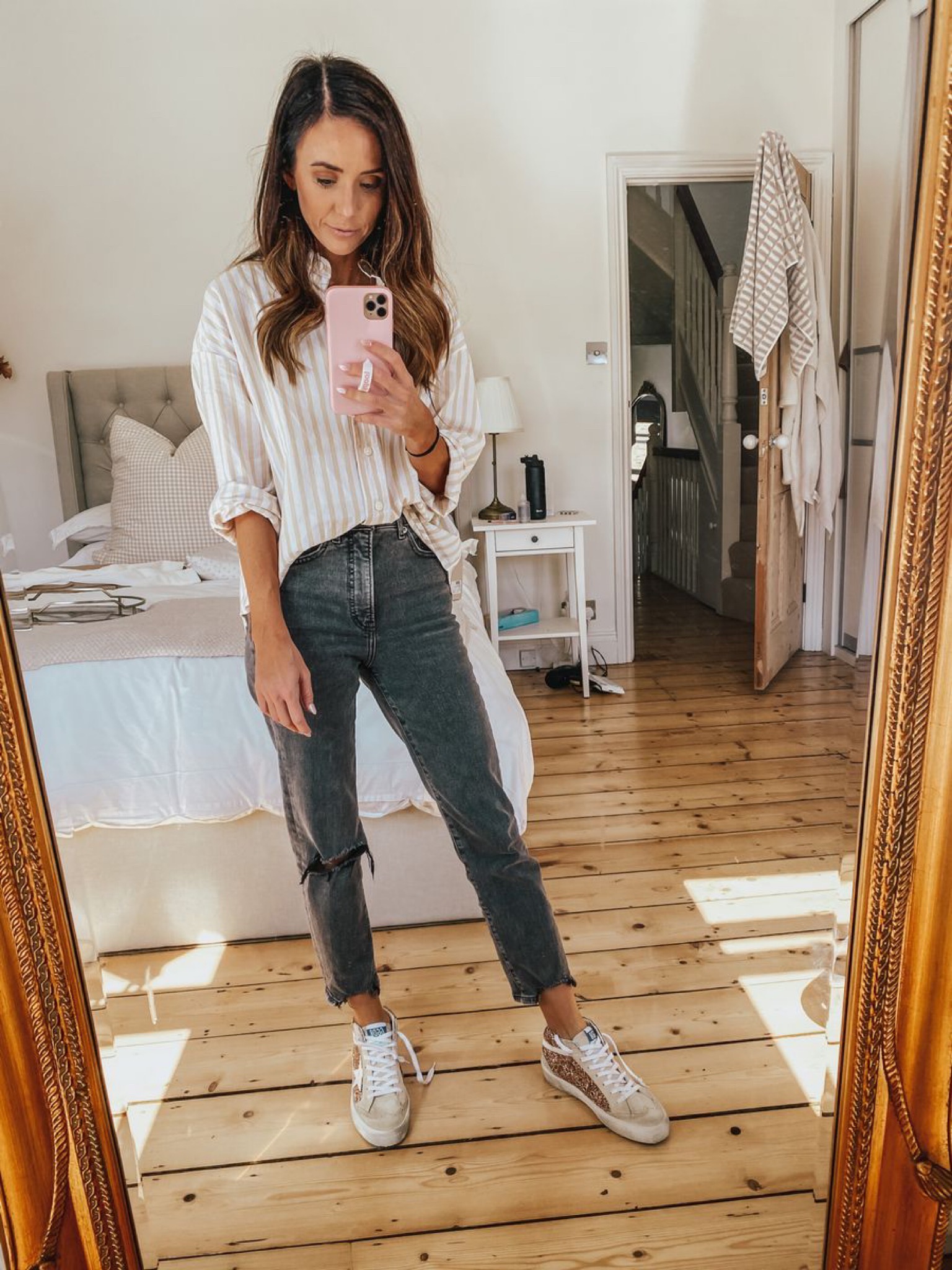 striped boyfriend button down with black straight jeans, thanksgiving day outfit ideas