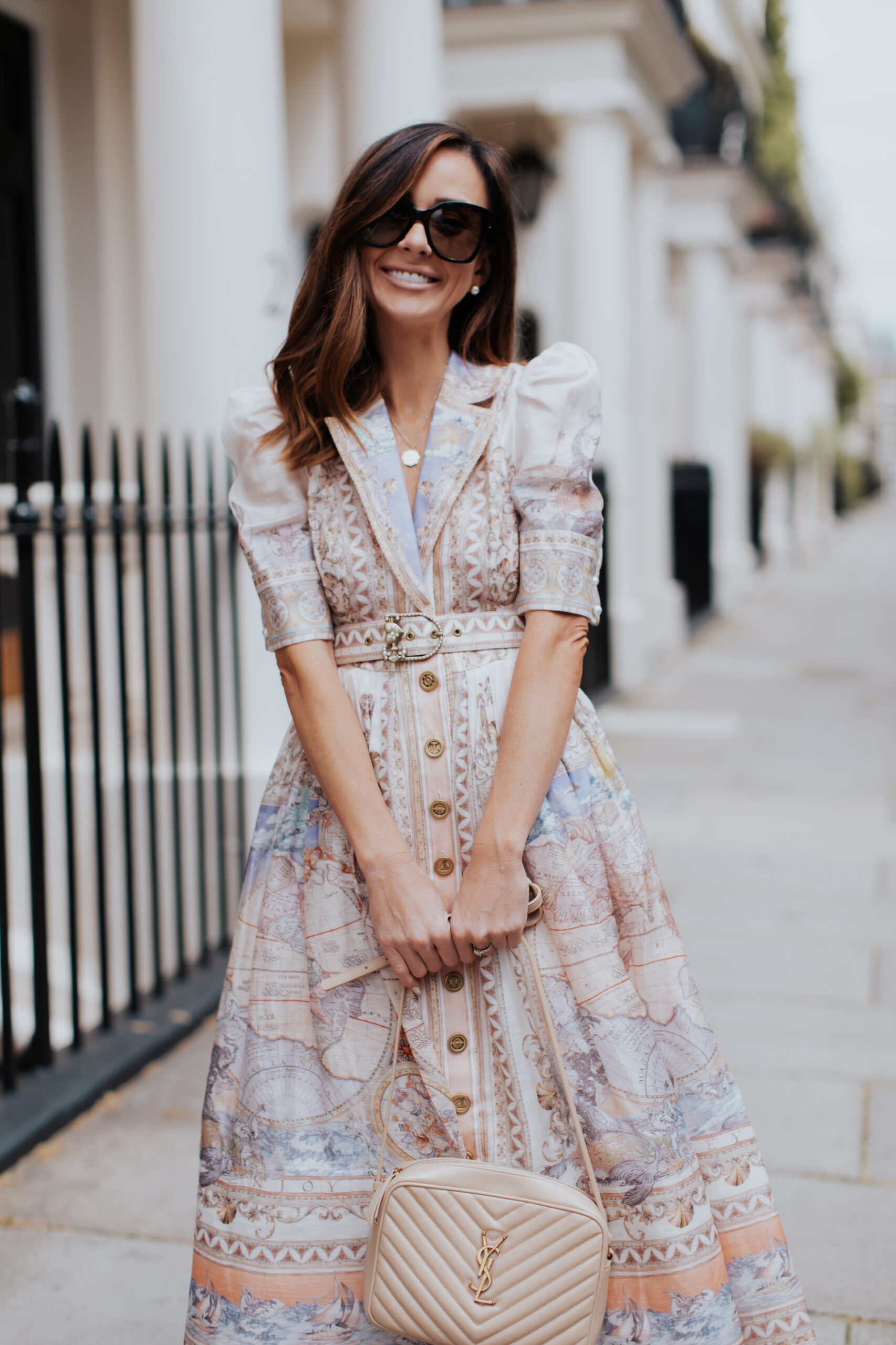 https://alysonhaley.com/wp-content/uploads/2023/06/brunette-woman-wearing-zimmerman-high-tide-map-print-shirt-dress-valentino-rockstud-heeled-sandals-in-london18-scaled.jpg